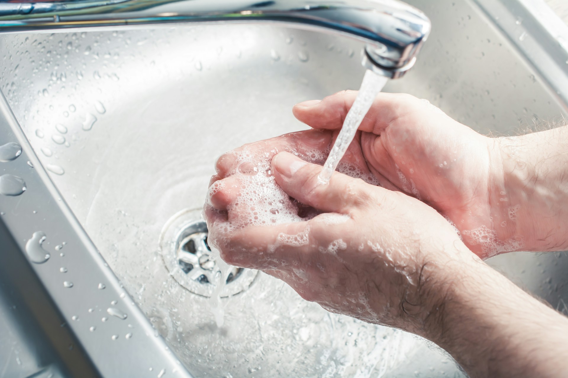 washing hands in sink